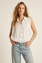 Q2 Blouse blanche sans manches à ourlet froncé avec boutons dorés