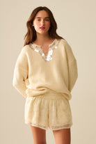 Q2 Pull à col en V crème avec détails en sequins